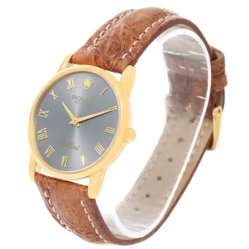 The image shows a side angle of a Rolex Cellini 5116 Yellow Gold Grey Dial 5116 Yellow Gold Grey Dial watch with a gold case and brown leather strap.