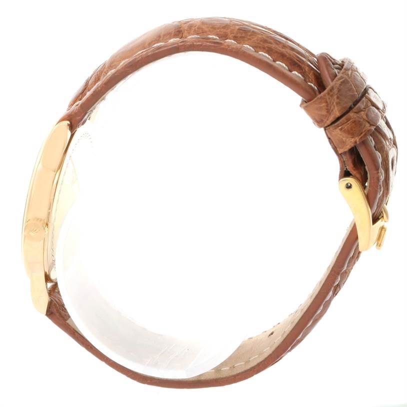 This side view of the Rolex Cellini 5116 Yellow Gold Grey Dial 5116 Yellow Gold Grey Dial watch shows its brown leather strap and gold buckle.