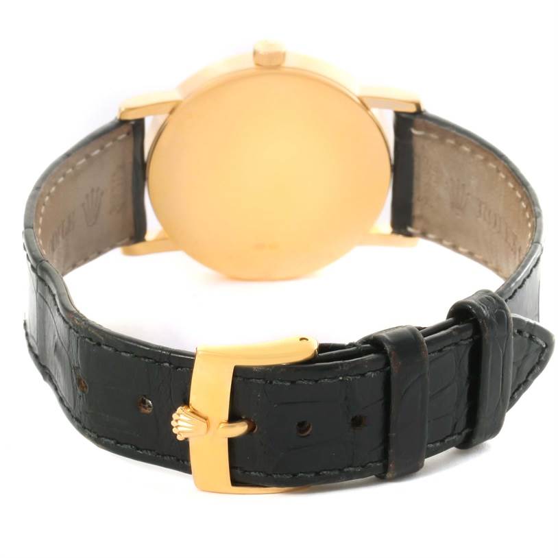 The image shows the rear view of a Rolex Cellini 5115 Yellow Gold Mother of Pearl Dial 5115 Yellow Gold Mother of Pearl Dial watch
s case and leather strap with the buckle facing forward.