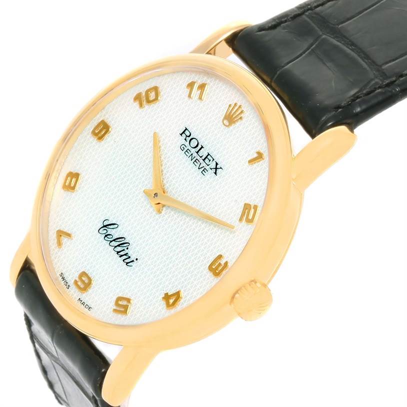 The Rolex Cellini 5115 Yellow Gold Mother of Pearl Dial 5115 Yellow Gold Mother of Pearl Dial watch is shown from a tilted angle, highlighting the dial, crown, and part of the black leather strap.
