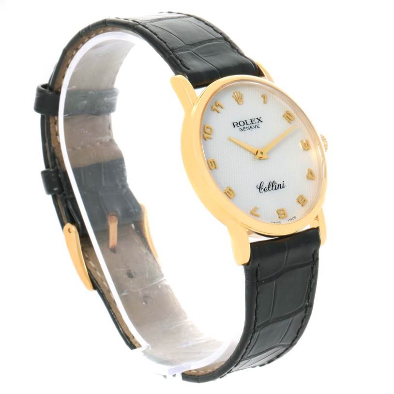 The image shows a side view of a Rolex Cellini 5115 Yellow Gold Mother of Pearl Dial 5115 Yellow Gold Mother of Pearl Dial watch featuring a black leather strap and a gold case with a white dial.