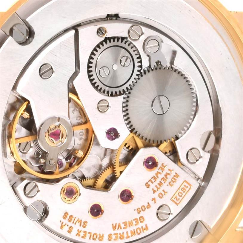The image shows the movement mechanism and gears of a Rolex Cellini 5115 Yellow Gold Mother of Pearl Dial 5115 Yellow Gold Mother of Pearl Dial watch from a close-up, top-down perspective.