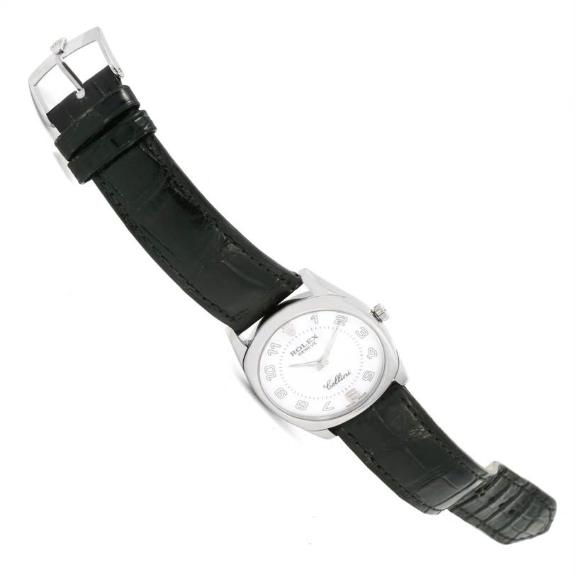 The Rolex Cellini 4233 White Gold White Dial 4233 White Gold White Dial watch is displayed at a top-down angle, showcasing its round dial, case, and black leather strap.