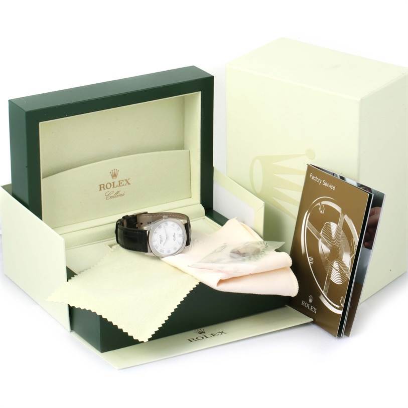 The image shows a Rolex Cellini 4233 White Gold White Dial 4233 White Gold White Dial watch with its open box, cleaning cloths, and a manual.