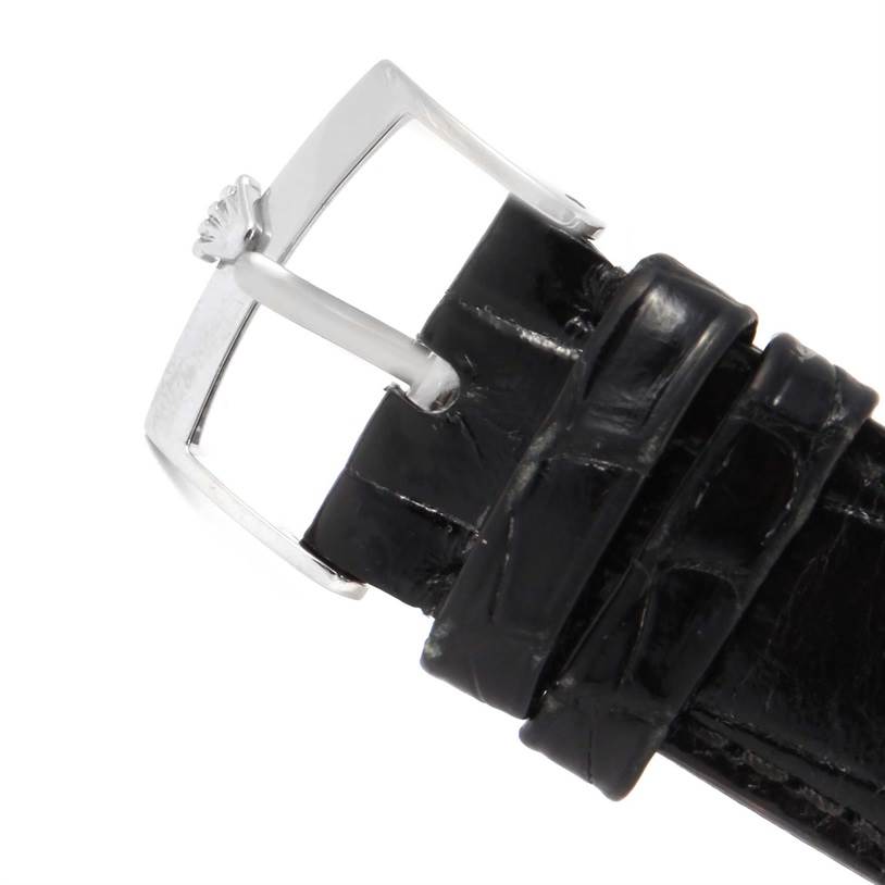 This image shows a close-up of the black leather strap and silver buckle of a Rolex Cellini 4233 White Gold White Dial 4233 White Gold White Dial watch.