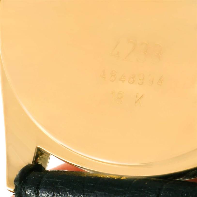 The image shows the back of a Rolex Cellini 4233 Yellow Gold White Dial 4233 Yellow Gold White Dial watch, highlighting its engraved model number and 18K gold marking with part of the strap visible.