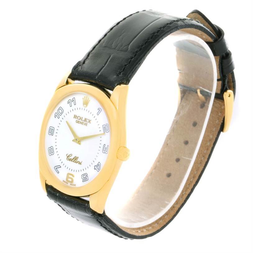 The Rolex Cellini 4233 Yellow Gold White Dial 4233 Yellow Gold White Dial watch is shown at an angled view, displaying the face, case, and leather strap.