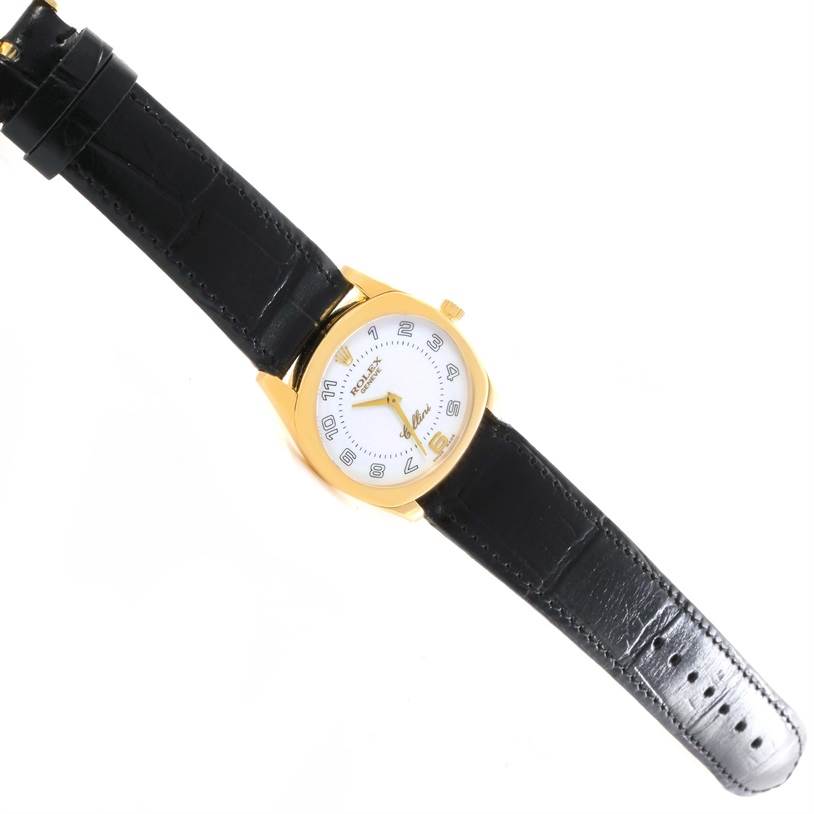 The image shows a Rolex Cellini 4233 Yellow Gold White Dial 4233 Yellow Gold White Dial watch with a gold case, white dial, and black leather strap laid flat.