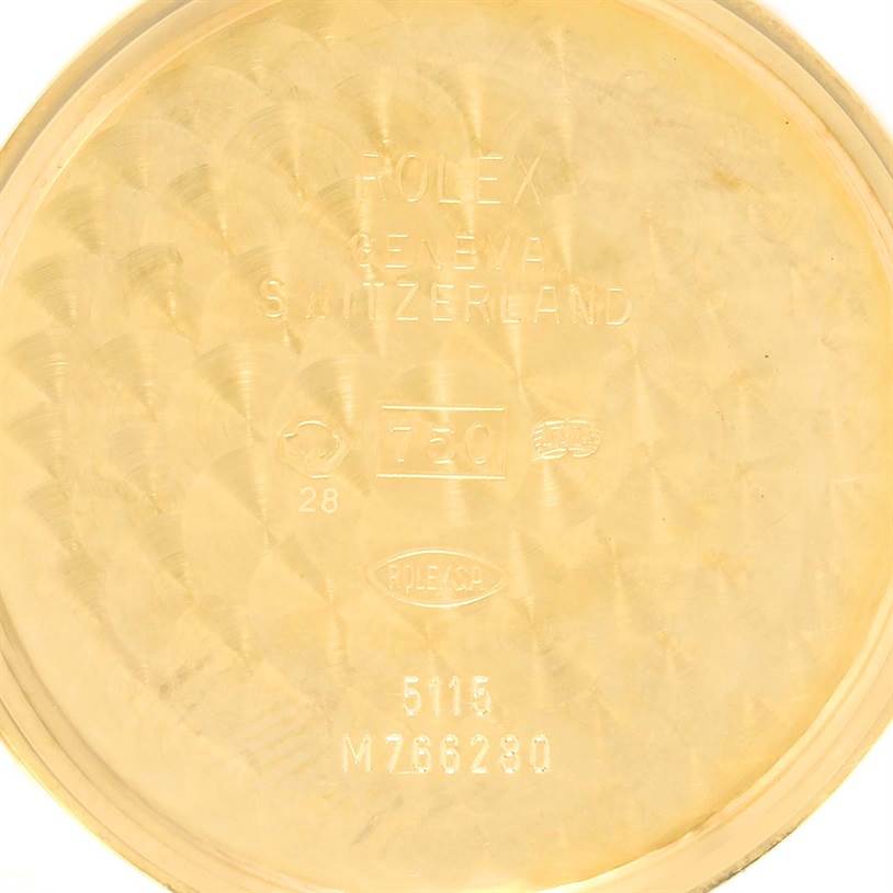 This image shows the inside of the back case of a Rolex Cellini 5115 Men's Yellow Gold Champagne Dial 5115 Men's Yellow Gold Champagne Dial watch, featuring text and markings.