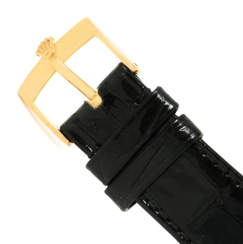 This image shows a close-up of a black leather strap and gold buckle of a Rolex Cellini 5116 Men's Yellow Gold Beige Dial 5116 Men's Yellow Gold Beige Dial watch.