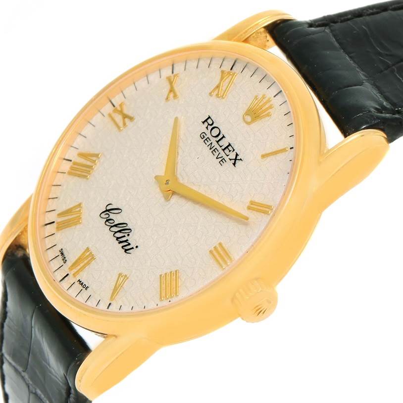 The image shows a Rolex Cellini 5116 Men's Yellow Gold Beige Dial 5116 Men's Yellow Gold Beige Dial watch at an angle highlighting the face, gold Roman numeral markers, and black leather strap.