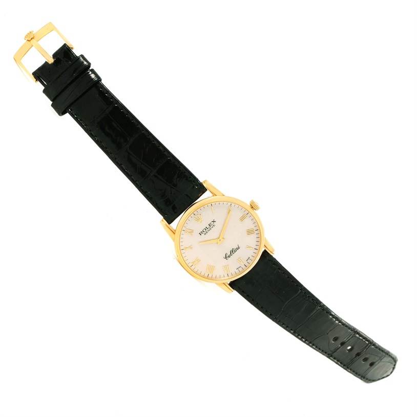 The Rolex Cellini 5116 Men's Yellow Gold Beige Dial 5116 Men's Yellow Gold Beige Dial watch is displayed from a top-down perspective, showing the dial, strap, and buckle.