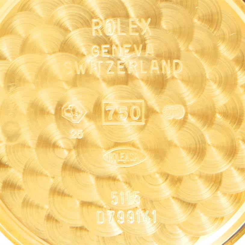 This image shows the inside case back of a Rolex Cellini 5115 Men
s Yellow Gold Champagne Dial 5115 Men
s Yellow Gold Champagne Dial watch, displaying various engravings and hallmark stamps.