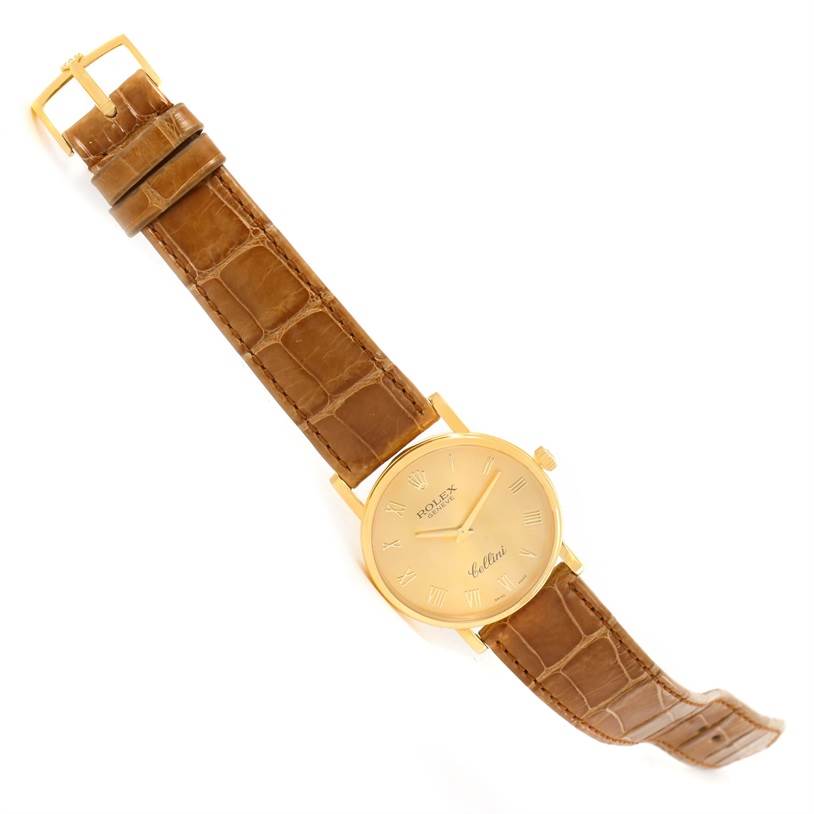 This image shows a Rolex Cellini 5115 Men
s Yellow Gold Champagne Dial 5115 Men
s Yellow Gold Champagne Dial watch at a slight angle, highlighting its tan leather strap, gold case, and buckle.