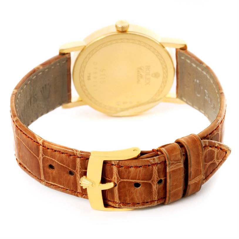 The image shows the back case and brown leather strap with a gold buckle of the Rolex Cellini 5115 Men
s Yellow Gold Champagne Dial 5115 Men
s Yellow Gold Champagne Dial model watch from a rear angle.