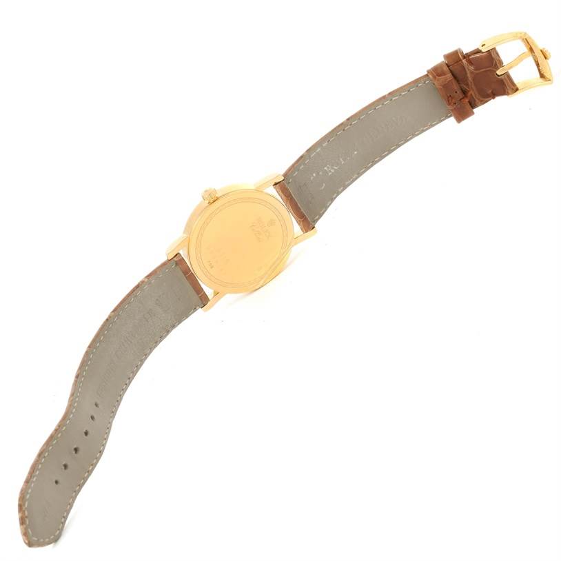 The image shows the back view of a Rolex Cellini 5115 Men
s Yellow Gold Champagne Dial 5115 Men
s Yellow Gold Champagne Dial watch, featuring the case back and leather strap with the buckle.