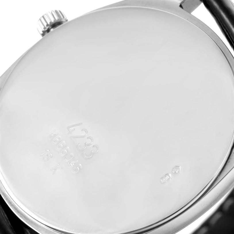 The image shows the back case of a Rolex Cellini 4233 Men
s White Gold Black Dial 4233 Men
s White Gold Black Dial model watch, displaying its serial number and crown.