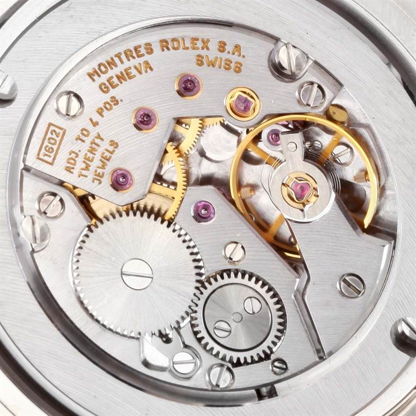 This image shows the intricate mechanics and movements of a Rolex Cellini 4233 Men
s White Gold Black Dial 4233 Men
s White Gold Black Dial watch from a close-up, internal angle.