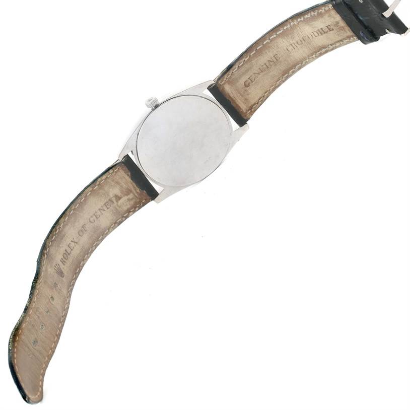 The image shows the back side of a Rolex Cellini 4233 Men
s White Gold Black Dial 4233 Men
s White Gold Black Dial watch, including the closed leather strap.