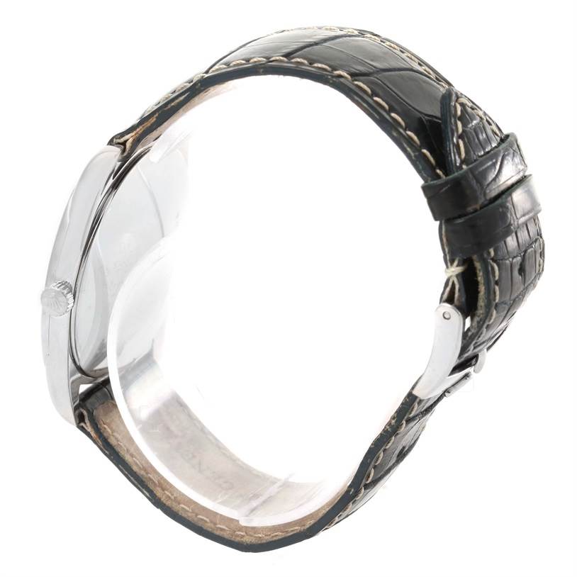 The image shows a side view of a Rolex Cellini 4233 Men
s White Gold Black Dial 4233 Men
s White Gold Black Dial watch, highlighting its black leather strap and metal buckle.