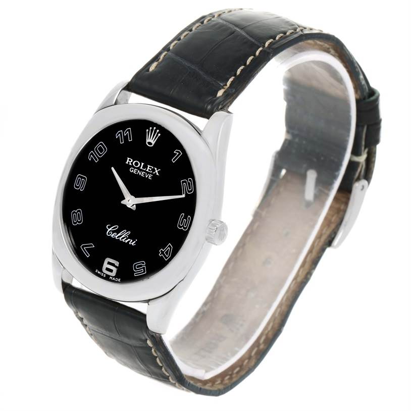 The image shows a Rolex Cellini 4233 Men
s White Gold Black Dial 4233 Men
s White Gold Black Dial watch at an angle displaying the black dial, silver hands, and black leather strap.