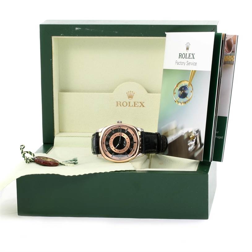 The image shows a Rolex Cellini 4243 Men
s White Gold Black Dial 4243 Men
s White Gold Black Dial watch, centered inside of an open green Rolex box with accompanying booklets and a Rolex tag.