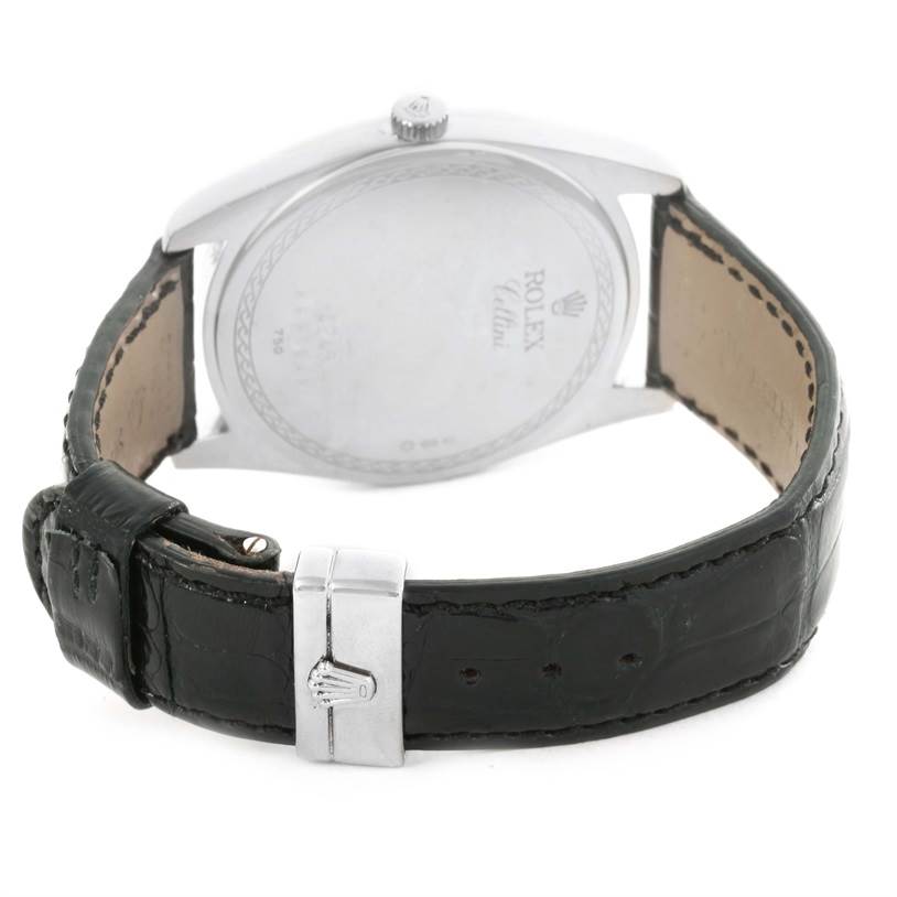 The image shows the back of a Rolex Cellini 4243 Men
s White Gold Black Dial 4243 Men
s White Gold Black Dial watch, highlighting its leather strap and metal clasp.