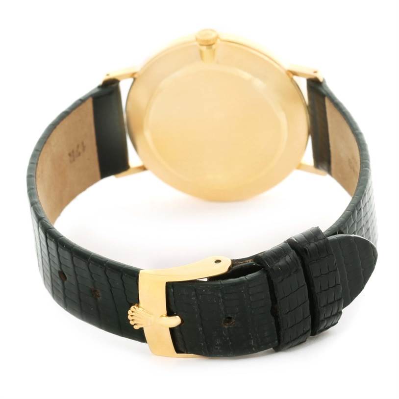 The image shows the rear view of a Rolex Cellini 5112 Men's Yellow Gold Champagne Dial 5112 Men's Yellow Gold Champagne Dial watch focusing on the case back and leather strap with a gold buckle.