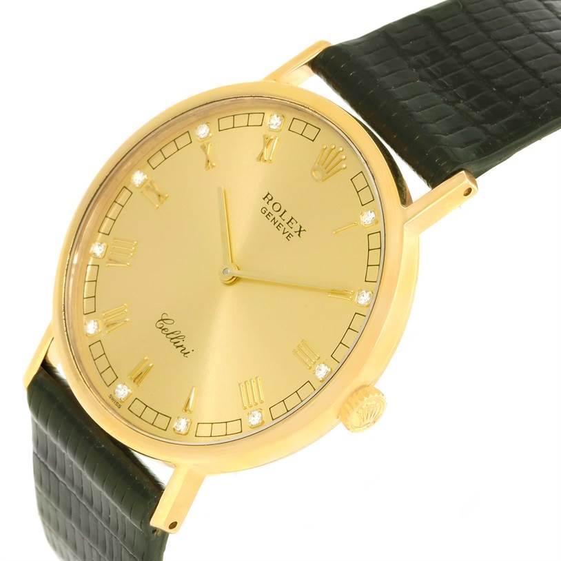 The image shows a close-up angled view of the Rolex Cellini 5112 Men's Yellow Gold Champagne Dial 5112 Men's Yellow Gold Champagne Dial watch, highlighting its gold case, dial, and black leather strap.