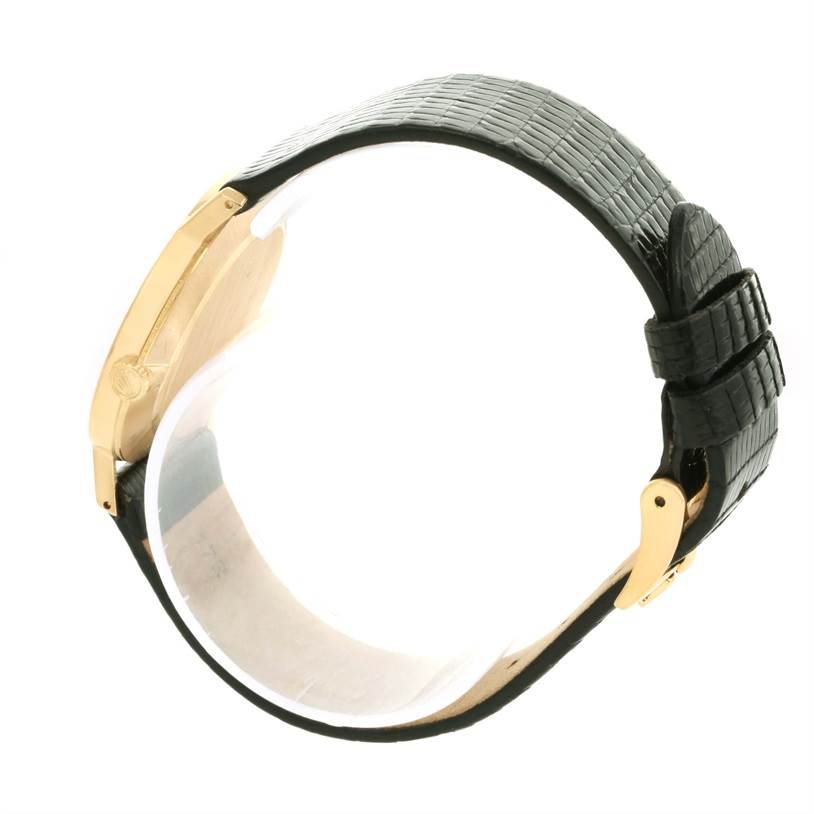 The image shows a side view of the Rolex Cellini 5112 Men's Yellow Gold Champagne Dial 5112 Men's Yellow Gold Champagne Dial watch, focusing on the black leather strap and the gold case.