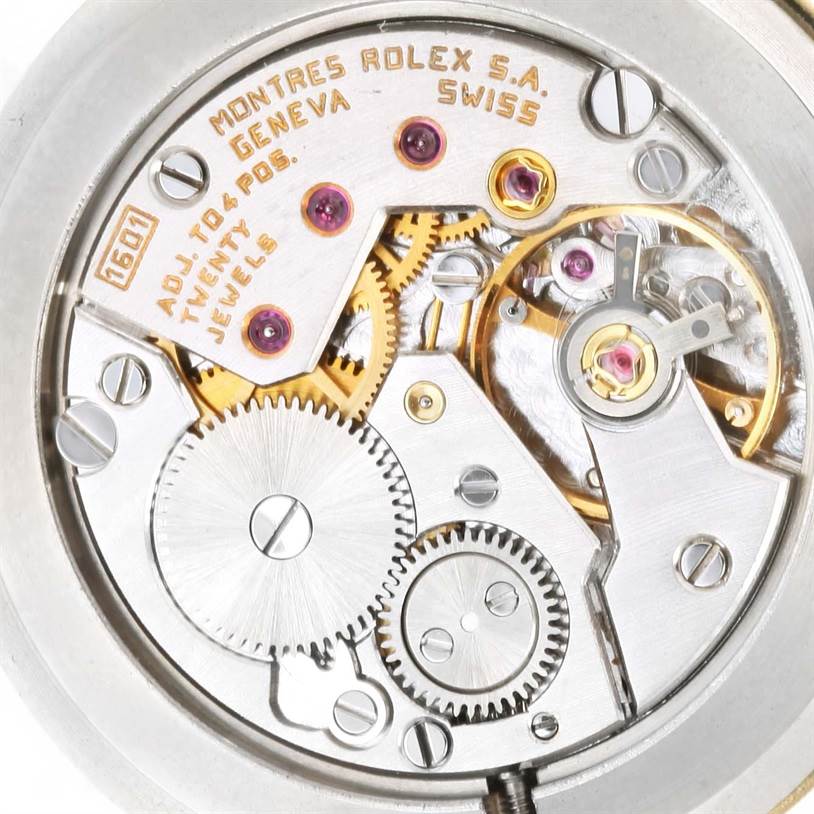 This image shows the intricate mechanical movement and gears inside a Rolex Cellini 5112 Men's Yellow Gold Champagne Dial 5112 Men's Yellow Gold Champagne Dial watch at a close-up angle.