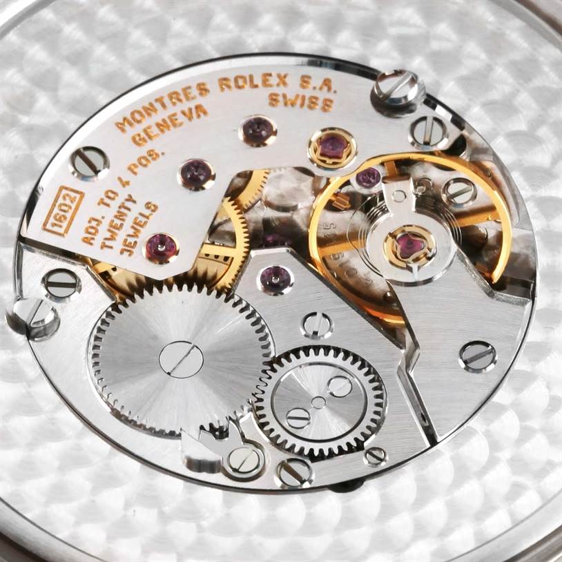 This is a close-up view of the Rolex Cellini 4243 Men's White Gold Black Dial 4243 Men's White Gold Black Dial watch movement, showing gears, screws, and jewels.