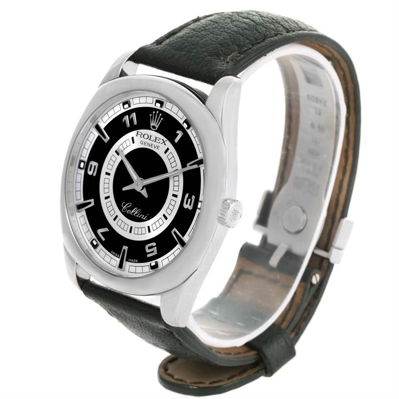 The Rolex Cellini 4243 Men's White Gold Black Dial 4243 Men's White Gold Black Dial watch is shown at an angle highlighting its black face, silver case, and black leather strap with the clasp visible.