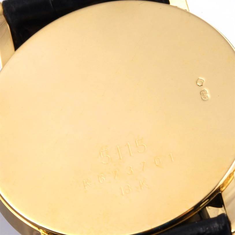 This image shows the case back of a Rolex Cellini 5115 Yellow Gold Silver Dial 5115 Yellow Gold Silver Dial watch, including its engravings and hallmarks.