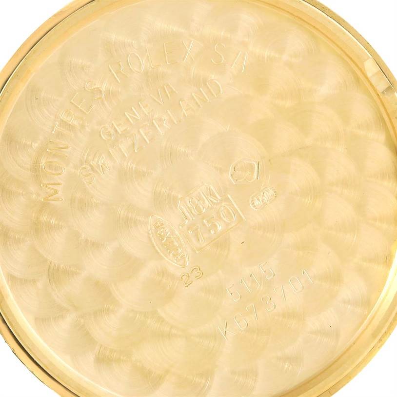 This image shows the inside case back of a 18k gold Rolex Cellini 5115 Yellow Gold Silver Dial 5115 Yellow Gold Silver Dial watch, featuring engravings and hallmarks.