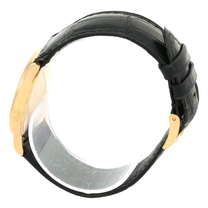 The image shows a Rolex Cellini 5115 Yellow Gold Silver Dial 5115 Yellow Gold Silver Dial model watch from a side angle, highlighting its leather strap and gold case.