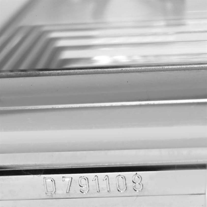 This close-up image of a Rolex Cellini 5443 Men's White Gold Black Dial 5443 Men's White Gold Black Dial watch shows the serial number "D791108" engraved on its case.