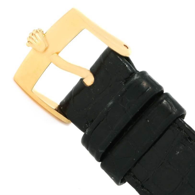 The image shows the buckle and part of the leather strap of a Rolex Cellini 5115 Men's Yellow Gold Black Dial 5115 Men's Yellow Gold Black Dial watch, featuring a gold clasp with the Rolex crown logo.