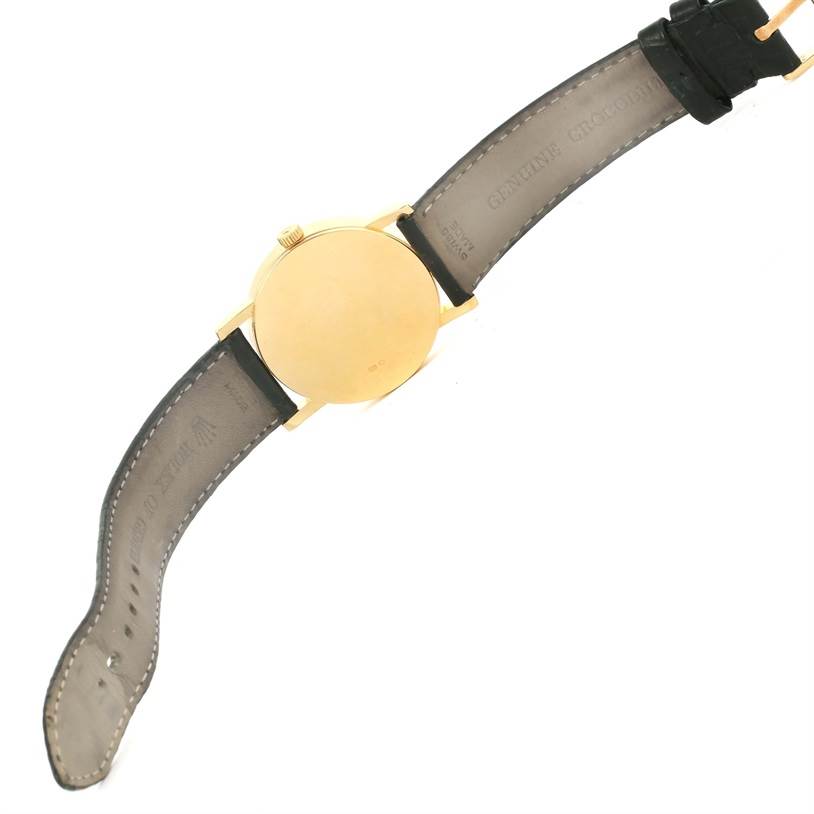 The image shows the back of a Rolex Cellini 5115 Men's Yellow Gold Black Dial 5115 Men's Yellow Gold Black Dial watch with its black leather strap fully extended.