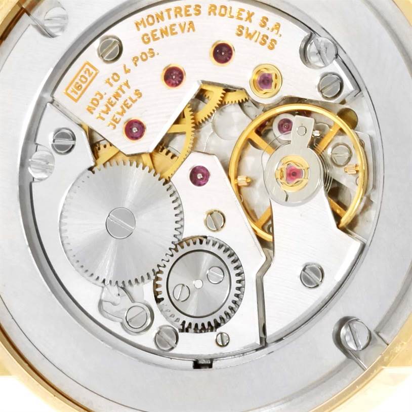 This image shows the intricate inner mechanism of the Rolex Cellini 5115 Men's Yellow Gold Black Dial 5115 Men's Yellow Gold Black Dial watch, highlighting its gears and components from a close-up angle.
