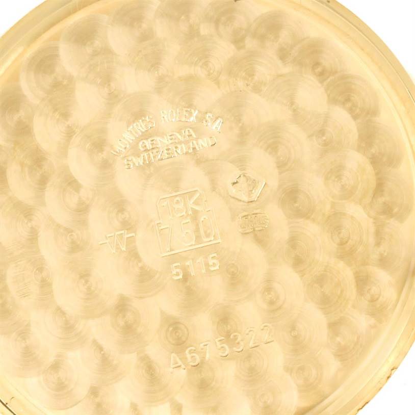 This image shows the inner case back of a Rolex Cellini 5115 Men's Yellow Gold Black Dial 5115 Men's Yellow Gold Black Dial model watch, engraved with hallmarks and serial numbers.