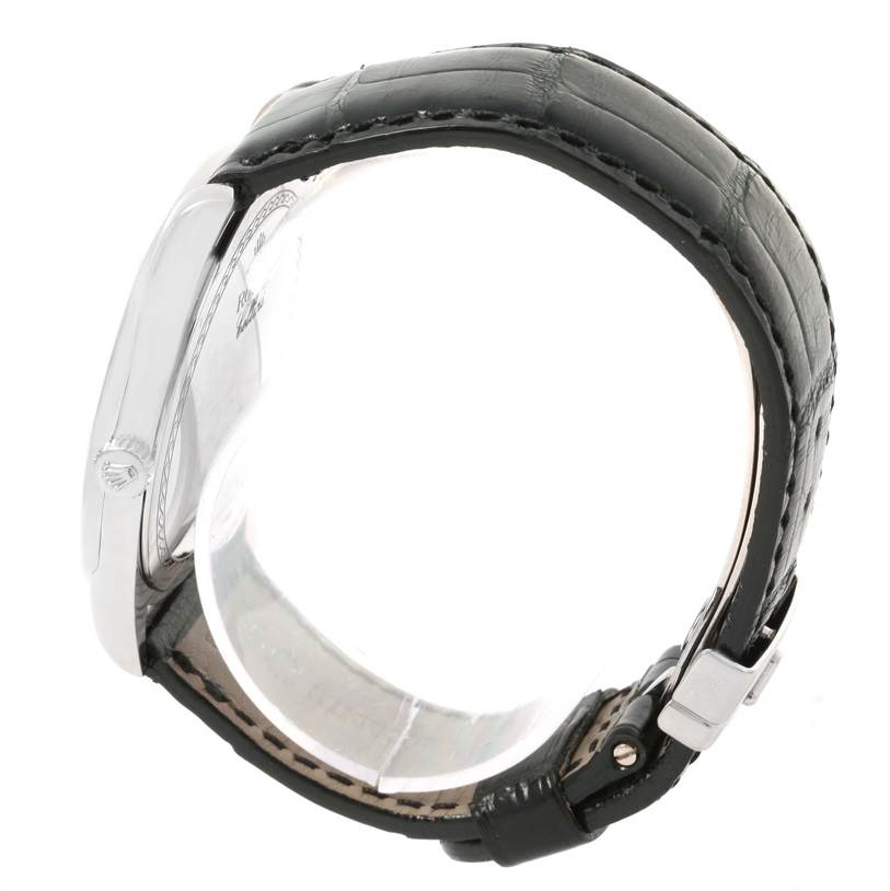 This side view of the Rolex Cellini 4243 Men's White Gold Black Dial 4243 Men's White Gold Black Dial watch displays its case and black leather strap with a clasp.