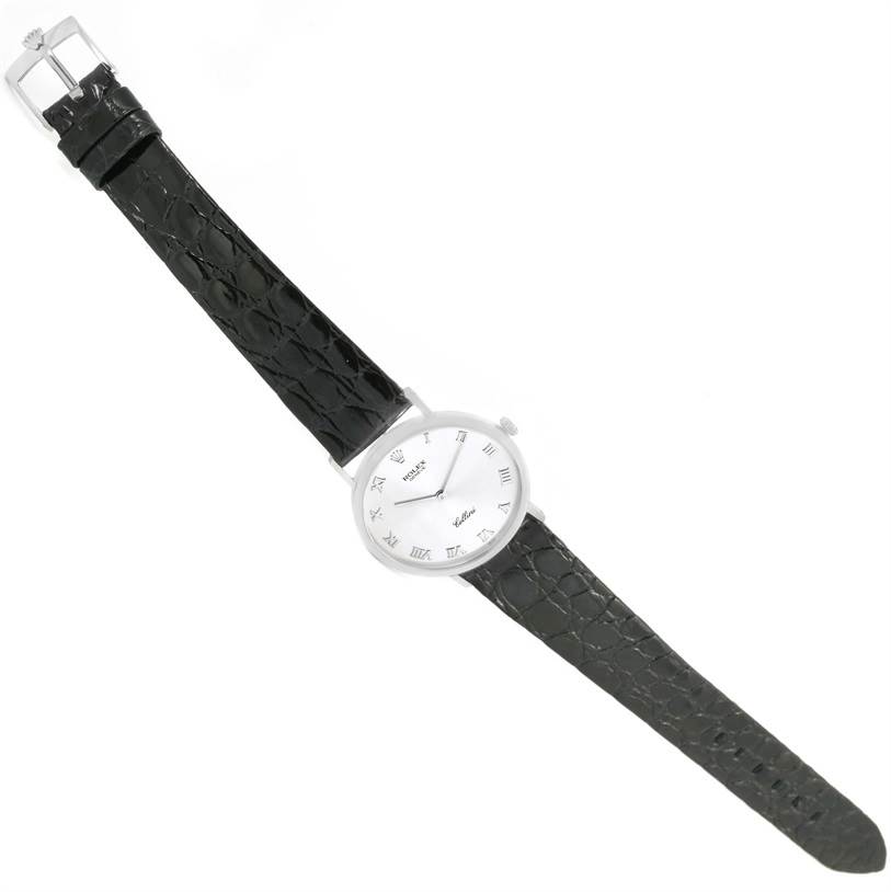 The image shows a full view of a Rolex Cellini 4112 Men
s White Gold Silver Dial 4112 Men
s White Gold Silver Dial watch from an overhead angle, displaying its face, black strap, and buckle.
