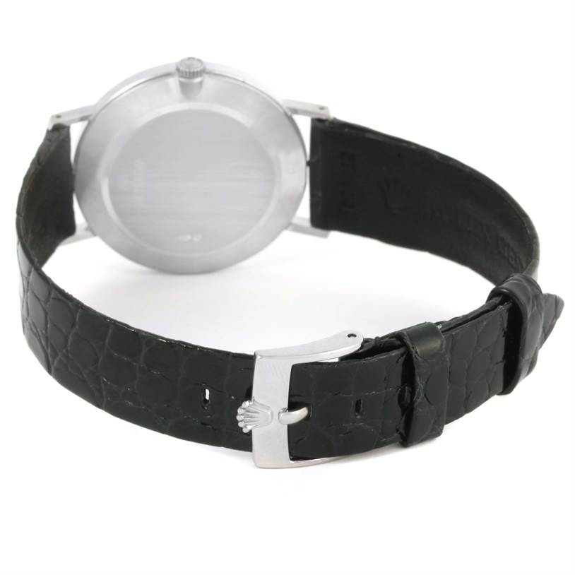 The image shows the back view of a Rolex Cellini 4112 Men
s White Gold Silver Dial 4112 Men
s White Gold Silver Dial watch, displaying its case back and black leather strap with a buckle.