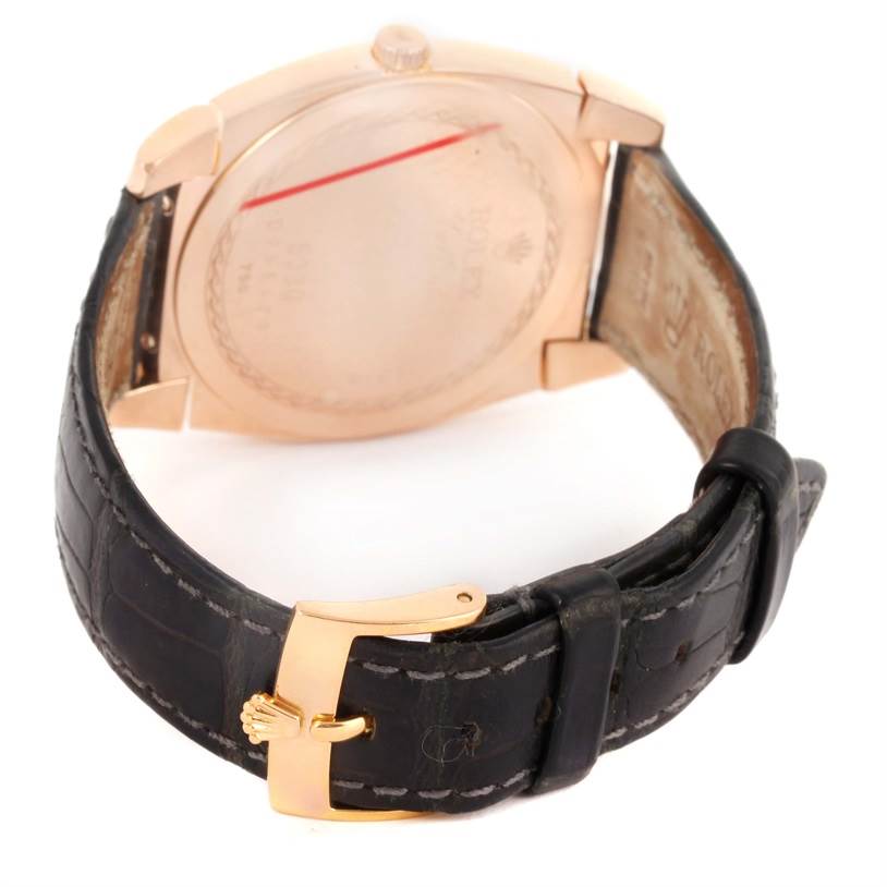 This image shows the back and buckle of a Rolex Cellini 5330 Men's Rose Gold Grey Dial 5330 Men's Rose Gold Grey Dial watch with a leather strap and gold accents.