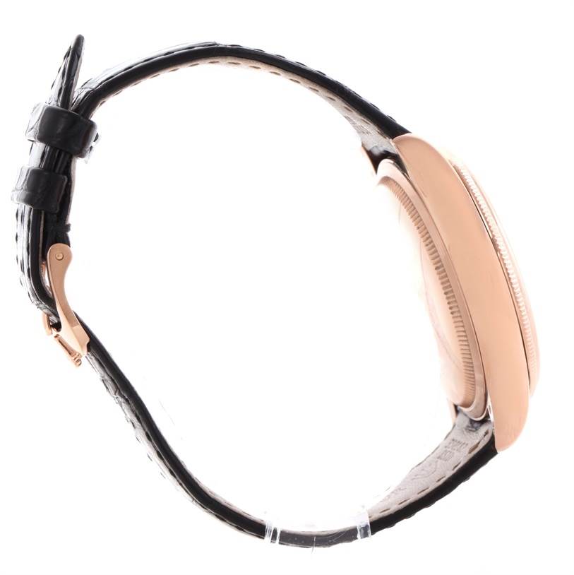 The side profile of the Rolex Cellini 50525 Men's Rose Gold Black Dial 50525 Men's Rose Gold Black Dial watch shows its rose gold case and black leather strap with a buckle.