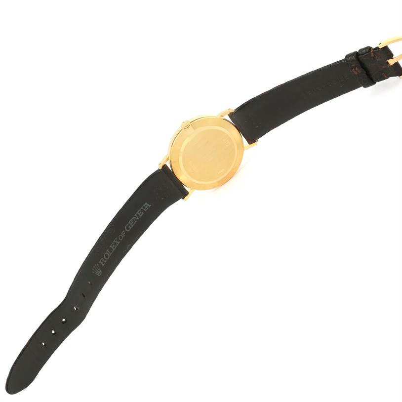 The image shows the back of a Rolex Cellini 4112 Men's Yellow Gold Champagne Dial 4112 Men's Yellow Gold Champagne Dial watch with a gold case and black leather strap.