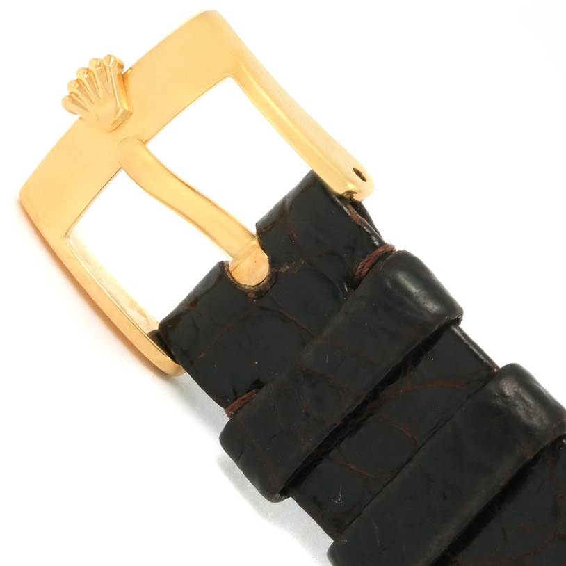 The image shows a close-up of the buckle and part of the leather strap of a Rolex Cellini 4112 Men's Yellow Gold Champagne Dial 4112 Men's Yellow Gold Champagne Dial model watch.