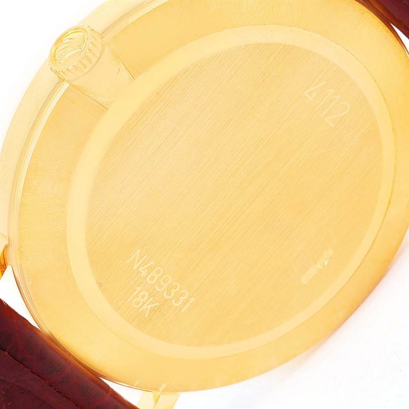 The image shows the back case and crown of the Rolex Cellini 4112 Men's Yellow Gold Champagne Dial 4112 Men's Yellow Gold Champagne Dial watch, highlighting its 18K gold and serial number.