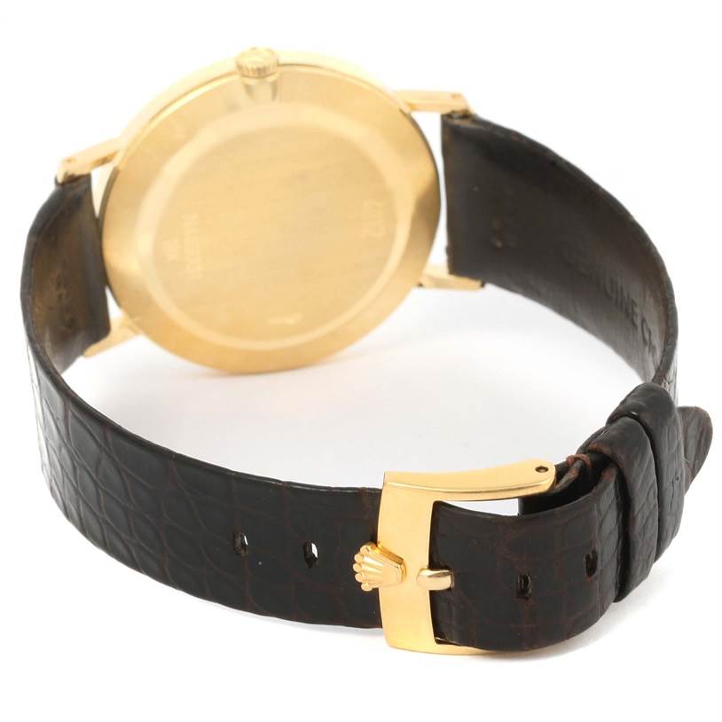 This image shows the back case, crown, and leather strap with buckle of a Rolex Cellini 4112 Men's Yellow Gold Champagne Dial 4112 Men's Yellow Gold Champagne Dial watch.